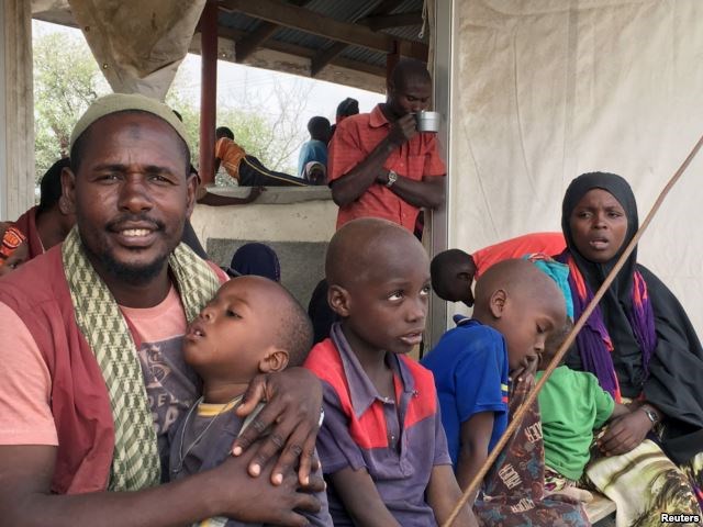 FILE - A Somali family waits to board a bus that will take them back home to Somalia from the Dadaab refugee camp in a voluntary repatriation programme, in Kenya, Jan. 21, 2016.